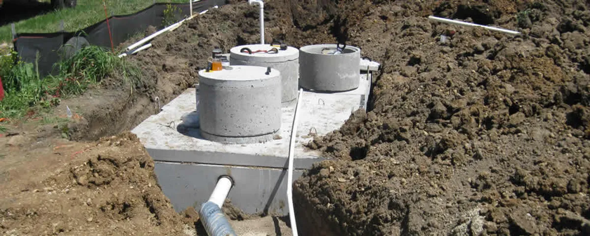 Septic system repair and installation site with tank access ports in Evansville, IN
